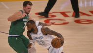 Luka Doncic #77 of the Dallas Mavericks guards LeBron James #23 of the Los Angeles Lakers in the first half at Staples Center on December 25, 2020 in Los Angeles, California. John McCoy/AFP
