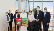 Representatives of Papa John’s Pizza handing vouchers to Nasser Al Naimi.