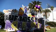 A fan pays tribute to late Kobe Bryant, who perished one year ago alongside his daughter and seven others when their helicopter crashed into a hillside near Los Angeles, gather outside the Staples Center in Los Angeles, California, U.S., January 26, 2021.