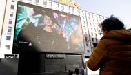 FILE PHOTO: A giant screen set up in San Babila square streams the Moschino Fall/Winter 2021/2022 digital show during Fashion Week in Milan, Italy, February 25, 2021. REUTERS/Alessandro Garofalo/File Photo