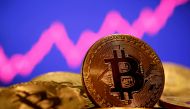 FILE PHOTO: A representation of virtual currency Bitcoin is seen in front of a stock graph in this illustration taken January 8, 2021. REUTERS/Dado Ruvic/File Photo
