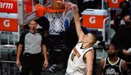 Denver Nuggets center Nikola Jokic (15) dunks for a basket in front of Los Angeles Clippers guard Paul George (13) during the second half at Staples Center. Gary A. Vasquez