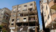 A Palestinian man inspects a damaged apartment in the aftermath of Israeli air strikes in Gaza City May 15, 2021. Reuters/Mohammed Salem
