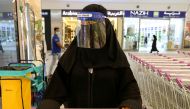 A Saudi woman, wearing a face shield, shops at a supermarket in Riyadh, Saudi Arabia. (REUTERS/Ahmed Yosri/File Photo)