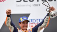 Repsol Honda's Marc Marquez celebrates with a trophy on the podium after winning the race REUTERS/Matthias Rietschel