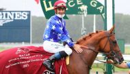 Jockey Oliver Peslier poses with Samlla after the victory.