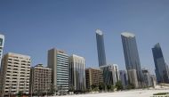 FILE PHOTO:An Emirati man wears a protective mask as he walks past buildings in Abu Dhabi, United Arab Emirates September 1, 2020. REUTERS/Nir Elias/Pool/File Photo