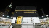 Officials replace the new covering cloth of the holy Kaaba (Kiswa) during the annual Haj pilgrimage, in the holy city of Mecca, Saudi Arabia, July 18, 2021. Saudi Ministry of Media/Handout via REUTERS