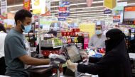 People wearing protective face masks and gloves shop at a supermarket in Riyadh, Saudi Arabia. (Reuters/Ahmed Yosri/File Photo)