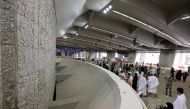 Pilgrims cast stones at pillars symbolizing Satan during the annual Haj pilgrimage, amid the coronavirus disease (COVID-19) pandemic, in Mina, near the holy city of Mecca, Saudi Arabia, July 20, 2021. (REUTERS/Ahmed Yosri)