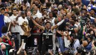 Milwaukee Bucks forward Giannis Antetokounmpo (34) celebrates with the NBA Finals MVP Trophy following the game against the Phoenix Suns following game six of the 2021 NBA Finals at Fiserv Forum. Jeff Hanisch