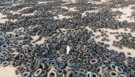 A general view shows used tyres in front of tyres recycling factory in Al Salmi area, Kuwait, yesterday.