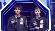 Japan's Shunsuke Togami and Hina Hayata pose with the champion's trophies after winning the mixed doubles title at the Lusail Sports Arena yesterday.