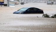 A car is partially submerged on a flooded street as Cyclone Shaheen makes landfall in Muscat Oman, October 3, 2021. REUTERS/Sultan Al Hassani