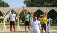 Bilal Al Saadi of Rasen Adventure Shop celebrates with other podium winners and an official after winning Race A.