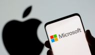 Microsoft logo is seen on the smartphone in front of displayed Apple logo in this illustration taken, July 26, 2021. REUTERS/Dado Ruvic/Illustration/File Photo