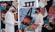 Grantee Abdulaziz Elepsy (right), a Grade 11 student at Qatar Academy Doha, exhibiting the products made from recycling old clothes at Education City Student Center.