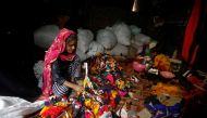 A woman sorts discarded fabric waste at a market in New Delhi, India, November 4, 2021. REUTERS/Adnan Abidi