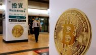 Advertisements for crypto exchange show a Bitcoin symbol at Mass Transit Railway (MTR) station, in Hong Kong, China. October 27, 2021. Reuters/Tyrone Siu/File Photo