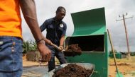 Agents remove organic fertilizer from an Award-winning biowaste converter Kubeko machine, in Nandibo, Ivory Coast October 19, 2021. Picture taken October 19, 2021. REUTERS/ Luc Gnago