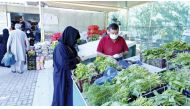 A customer buying vegetables from the Al Wakra yard.