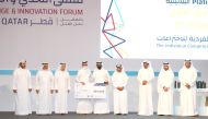 Minister of Sports and Youth H E Salah bin Ghanem Al Ali honouring a winner during the closing ceremony of the forum at QNCC.