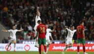 Portugal's Joao Cancelo looks dejected as Serbia players celebrate after winning the match and qualifying for the Qatar 2022 World Cup... Reuters/Pedro Nunes