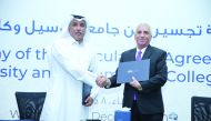 CCQ President Dr. Mohamed Ibrahim Al Naemi; Lusail University Provost, Professor Nitham Mohammed Hindi, shake hands after signing the agreement. 