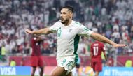 Algeria's Mohammed Belaili celebrates after scoring their second goal against Qatar.