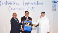 CNA-Q President Dr. Salem Al Naemi handing over a prize to an employee.  