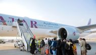 Afghan passengers board a Qatar Airways plane at Kabul International Airport, in Kabul, Afghanistan, on September 19, 2021. 