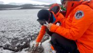 Argentine doctor Mariela Torres and intern doctor Nathalie Bernard take samples of the Antarctica soil for their project to use native microorganisms to clean up pollution from fuels and potentially plastics in the pristine expanses of the white continent, in Antarctica January 30, 2022. Florencia Brunetti/Handout via REUTERS