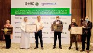 Officials with GSAS certificates during a ceremony.