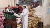 A municipal inspector checking quality of agricultural produce at an outlet.