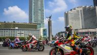 MotoGP racers ride passing the Bundaran Hotel Indonesia roundabout as they take part on a parade, ahead of the Indonesian Grand Prix that will be held this weekend at Pertamina Mandalika International Street Circuit on Lombok island, in Jakarta, Indonesia, March 16, 2022, in this photo taken by Antara Foto. Antara Foto/Galih Pradipta/via REUTERS