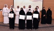 QU President Dr. Hassan Al Derham, Vice-President for Student Affairs Dr. Iman Mostafawi and other officials with the award-winning students. 