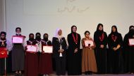 Minister of Education and Higher Education H E Buthaina bint Ali Al Jabr Al Nuaimi; Assistant Undersecretary for Educational Affairs Fawzia Abdulaziz Al Khater; and other officials and students during the honouring ceremony.