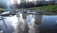 FILE PHOTO: The lignite (brown coal) power plant complex of German energy supplier and utility RWE is reflected in a large puddle in Neurath, northwest of Cologne, Germany, February 5, 2020. REUTERS/Wolfgang Rattay/File Photo
