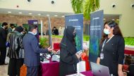 Organisation representatives talk with attendees at the job fair hosted at Texas A&M University at Qatar.