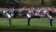  Tiger Woods, Justin Thomas and Fred Couples of the U.S. skim their shot on the water on the 16th during a practice round REUTERS/Mike Blake
