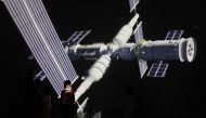 A child stands near a giant screen showing the image of the Tianhe space station on the country's Space Day at China Science and Technology Museum in Beijing, China April 24, 2021. Reuters/Tingshu Wang/File Photo

