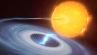 This artist's impression shows a two-star system where stellar explosions called micronovae may occur. The blue disc swirling around the bright white dwarf in the center of the image is made up of material, mostly hydrogen, stolen from its companion star. Towards the center of the disc, the white dwarf uses its strong magnetic fields to funnel the hydrogen towards its poles. As the material falls on the hot surface of the star, it triggers a micronova explosion, contained by the magnetic fields at one of the white dwarf's poles. European Southern Observatory/M. Kornmesser, L. Calcada/Handout via REUTERS