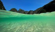 A partially underwater shot shows the waters at the beach of Maya Bay as Thailand reopens its world-famous beach after closing it for more than three years to allow its ecosystem to recover from the impact of overtourism, at Krabi province, Thailand, January 3, 2022. REUTERS/Jorge Silva/File Photo