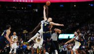 Denver Nuggets center Nikola Jokic (15) and Golden State Warriors forward Draymond Green (23) reach for a jump ball in the second half of the first round for the 2022 NBA playoffs at Ball Arena.  Ron Chenoy