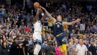 Minnesota Timberwolves forward Anthony Edwards (1) shoots a three-point field goal while guarded by Memphis Grizzlies forward Brandon Clarke (15) in game five of the first round for the 2022 NBA playoffs at FedExForum.  Christine Tannous 