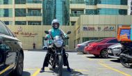 A food delivery worker rides a motorbike to deliver meal orders, following the outbreak of the coronavirus disease (COVID-19), in Dubai, United Arab Emirates, May 14, 2020. Reuters/Abdel Hadi Ramahi/File Photo