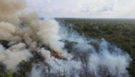 Billows of smoke rise over a deforested plot of the Amazon jungle next to the Transamazonica national highway, in Labrea, Amazonas state, Brazil, September 1, 2021. Picture taken September 1, 2021 with a drone. REUTERS/Bruno Kelly/File Photo