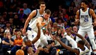 Phoenix Suns forward Jae Crowder (99) and center Bismack Biyombo (18) go for the ball against Dallas Mavericks guard Luka Doncic (77) and forward Dorian Finney-Smith (10) during the second quarter in game seven of the second round for the 2022 NBA playoffs at Footprint Center. Mark J. Rebilas-USA TODAY Sports