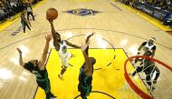 Golden State Warriors forward Andrew Wiggins (22) shoots the ball over Boston Celtics guard Derrick White (9) in game five of the 2022 NBA Finals at Chase Center. Jed Jacobsohn