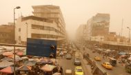 Cars drivers and residents gather at the Shorja wholesale market during a sandstorm in Baghdad, Iraq, July 3, 2022. (Reuters/Ahmed Saad)